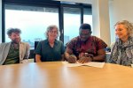 Daniel Banuoku signs the agreement 