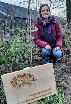 Rianne Kat with the tree she planted