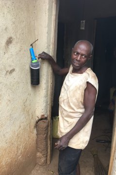 Participant in a malaria citizen science project demonstrating his mosquito trap.